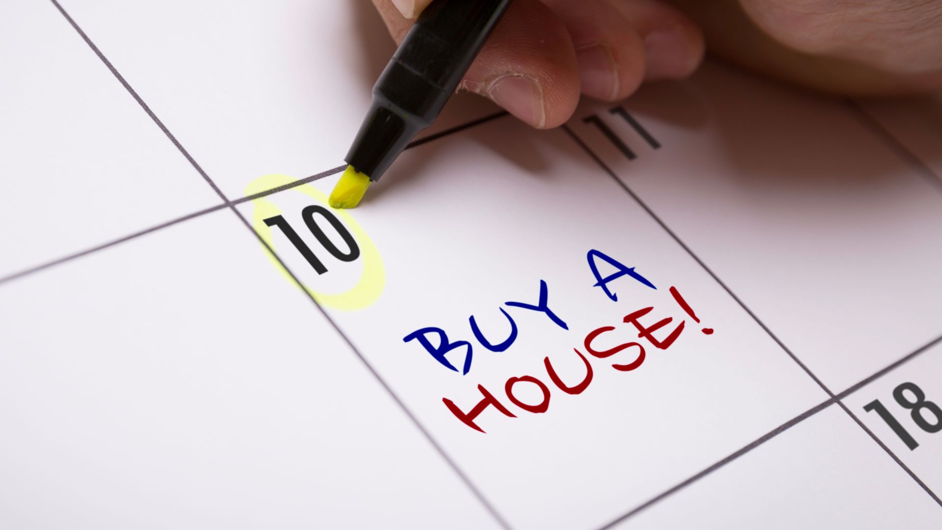 Calendar with highlighted date and "Buy a House!" reminder in colorful text