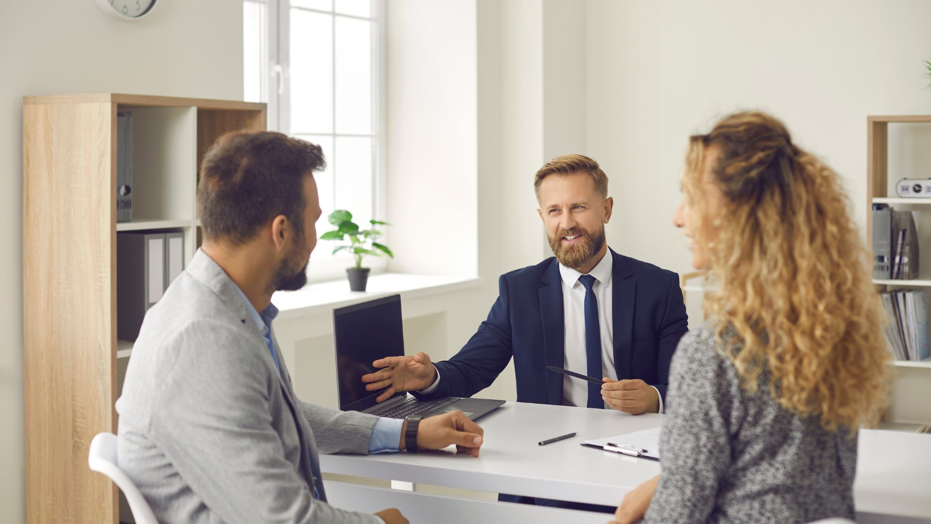 Business professionals in a meeting discussing work at office desk